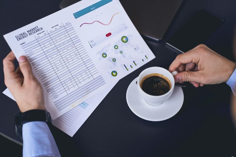 Market researcher scrutinizing a chart in his hand
